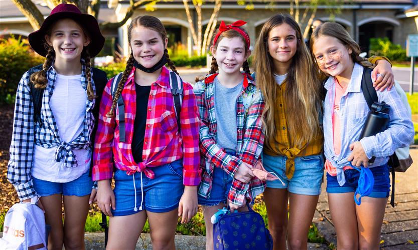 Students wearing western wear walk to school